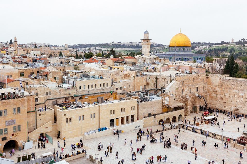 Tourists in Jerusalem with Western Wall and Dome of Rock, Israel