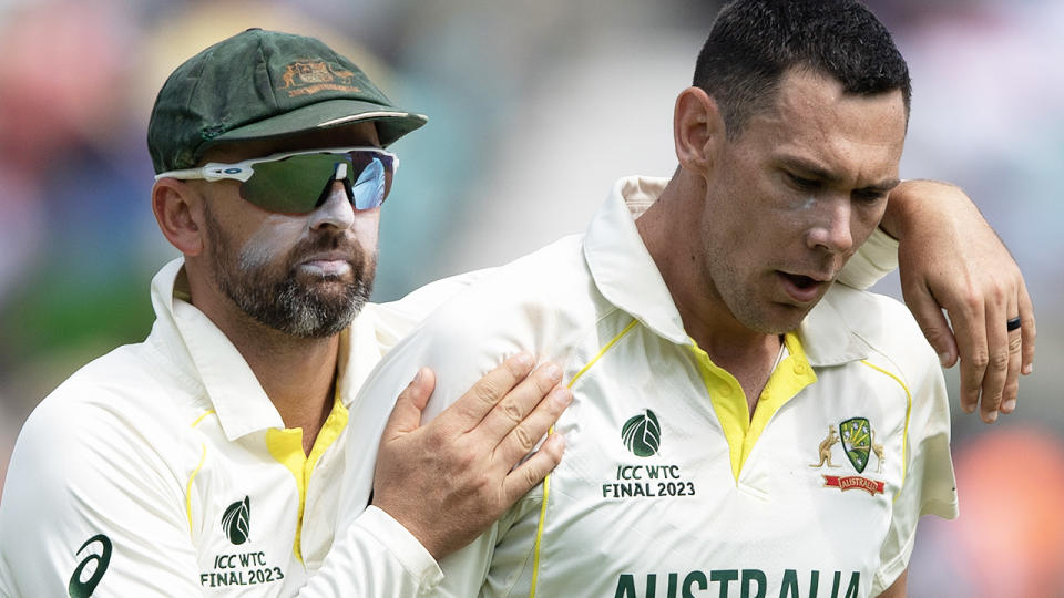 Scott Boland walks with teammate Nathan Lyon.