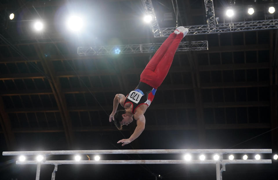 The Russian Olympic Committee's Artur Dalaloyan performs on the parallel bars during the men's artistic gymnastic qualifications at the 2020 Summer Olympics, Saturday, July 24, 2021, in Tokyo. (AP Photo/Gregory Bull)