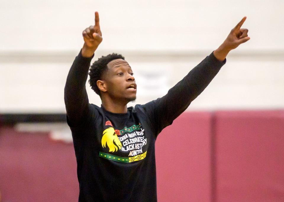 Peoria High head coach Daniel Ruffin gives directions to the Lionss as the battle Manual in the first half Saturday, Feb. 14, 2023 at Peoria High School. The Rams rallied to defeat the Lions 66-61.