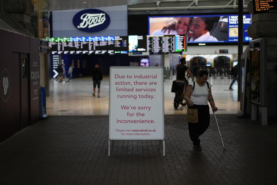 A strike sign is displayed by an entrance at Waterloo train station, in London, during a railway workers strike, Thursday, June 23, 2022. Millions of people in Britain faced disruption Thursday as railway staff staged their second national walkout this week. (AP Photo/Matt Dunham)