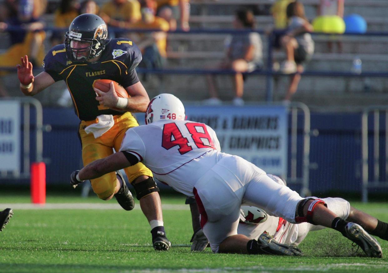 Kent State quarterback Julian Edelman is about to be tackled by Miami University linebacker Joe Hudson during second quarter at Dix Stadium, Saturday, Oct. 6, 2007.