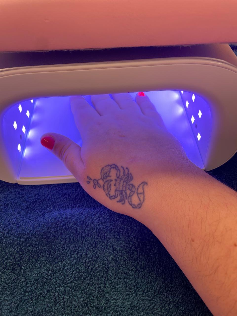 My BIAB nails curing under a UV-LED light.