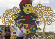 Nicaragua's President Daniel Ortega, accompanied by his wife, first lady Rosario Murillo, talks during an event to mark the first anniversary of the death of Venezuela's late president Hugo Chavez, in Managua, Nicaragua, Wednesday, March 5, 2014. (AP Photo/Esteban Felix)