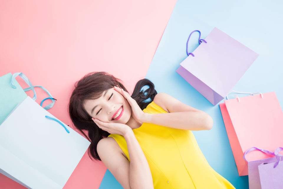 woman take shopping bag happily on the blue and pink background