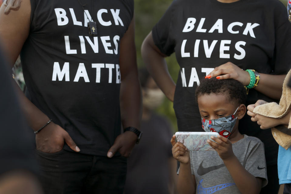 People attend a peaceful rally in Chicago, Friday, June 19, 2020, to mark Juneteenth, the holiday celebrating the day in 1865 that enslaved Black people in Galveston, Texas, learned they had been freed from bondage, more than two years after the Emancipation Proclamation. (AP Photo/Charles Rex Arbogast)
