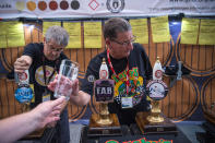 <p>Bar staff serve visitors at the CAMRA (Campaign for Real Ale) Great British Beer festival at Olympia exhibition center on August 8, 2017 in London, England. (Photo: Carl Court/Getty Images) </p>