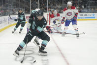 Seattle Kraken center Jaden Schwartz (17) passes the puck as Montreal Canadiens goaltender Jake Allen and defenseman David Savard, right, look on during the third period of an NHL hockey game, Tuesday, Oct. 26, 2021, in Seattle. The Kraken won 5-1. (AP Photo/Ted S. Warren)