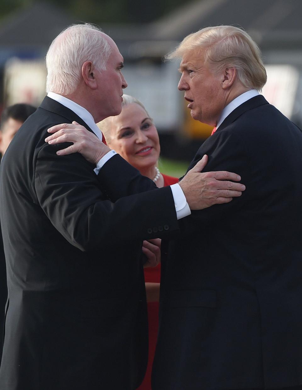 U.S. Rep. Mike Kelly, of Butler, R-3rd Dist., at left, and his wife Victoria, center, greet President Donald  J. Trump on Oct. 10, 2018 at the Erie International Airport.