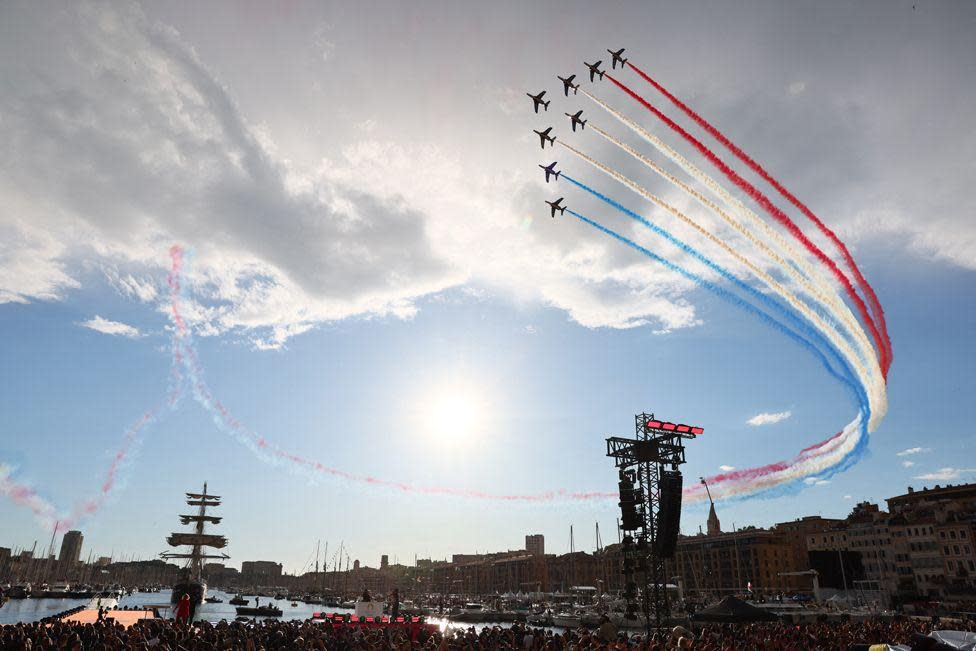 Planes fly in the air as the Olympic Flame arrives in Marseille