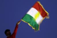 <p>A man waves a Kurdish flag during an event to urge people to vote in the upcoming independence referendum in Arbil, the capital of the autonomous Kurdish region of northern Iraq. (Photo: Safin Hamed/AFP/Getty Images) </p>