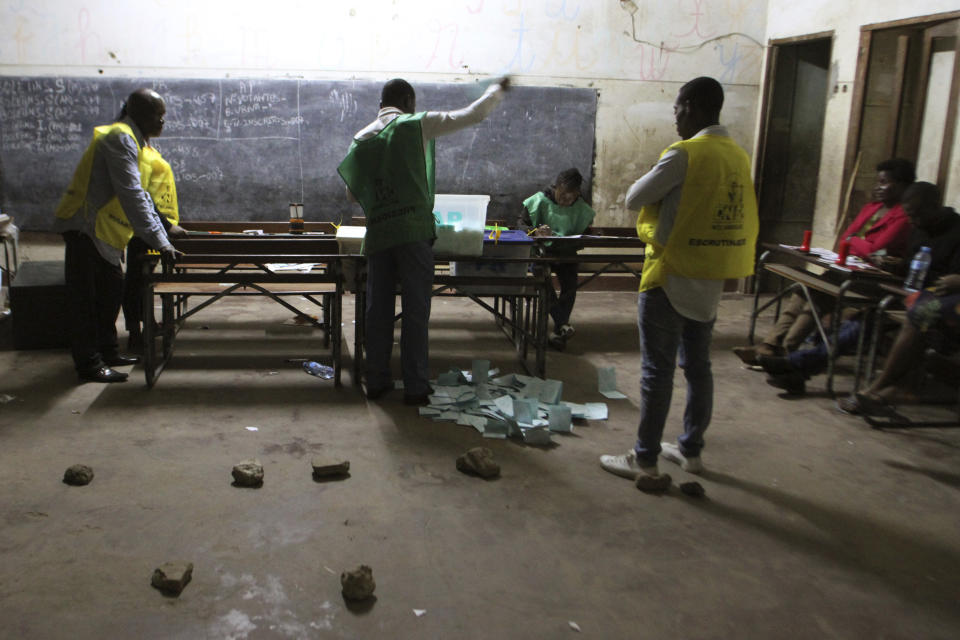 In this Tuesday, Oct. 15, 2019, photo, vote counting takes place after polling station closed in Maputo, Mozambique. Calls for calm and warnings against voter intimidation marked a closely watched election day in the country that is crucial in consolidating a wary peace in the southern African nation of nearly 30 million people. (AP Photo/Ferhat Momade)