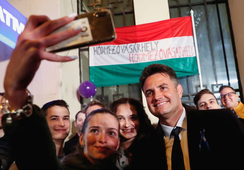 FILE PHOTO: Opposition candidate for prime minister Peter Marki-Zay poses for a selfie with supporters at the election headquarters in Budapest