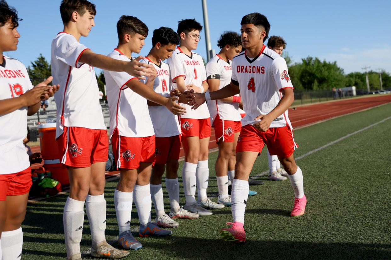 Purcell's Jonathan Resendiz slaps hands with teammates as he is introduced before a boys soccer game against Crossings Christian in Oklahoma City, Tuesday, April 16, 2024.