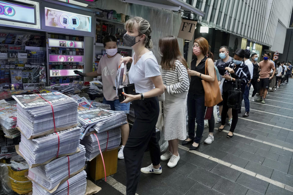 FILE - People queue up for last issue of Apple Daily at a newspaper booth at a downtown street in Hong Kong, June 24, 2021. ( AP Photo/Vincent Yu, File)