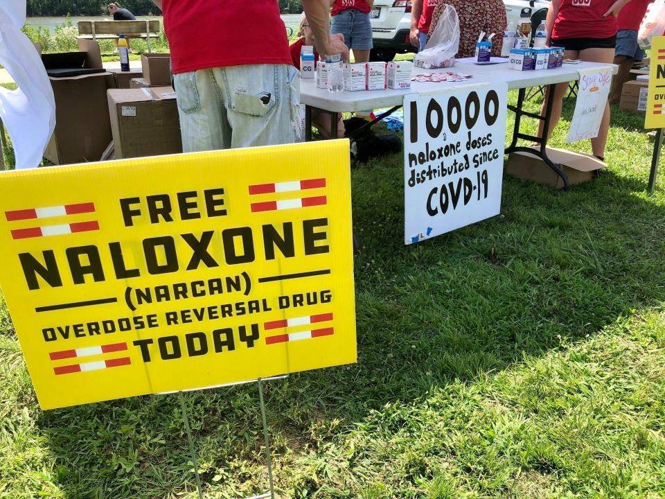 Signs are displayed at a tent during a health event on June 26, 2021, in Charleston, W.Va.