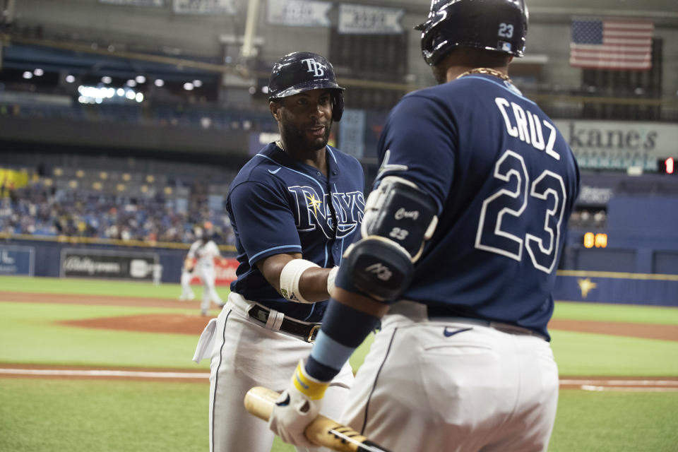 Tampa Bay Rays' Yandy Diaz, left, celebrates with Nelson Cruz after hitting a home run against the Detroit Tigers during the first inning of a baseball game Thursday, Sept. 16, 2021, in St. Petersburg, Fla. (AP Photo/Scott Audette)