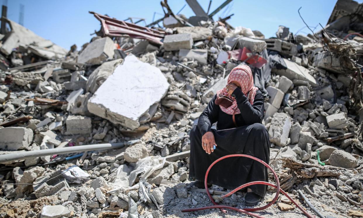 <span>A woman cries on rubble of a collapsed building in Khan Younis, Gaza.</span><span>Photograph: Anadolu/Getty Images</span>