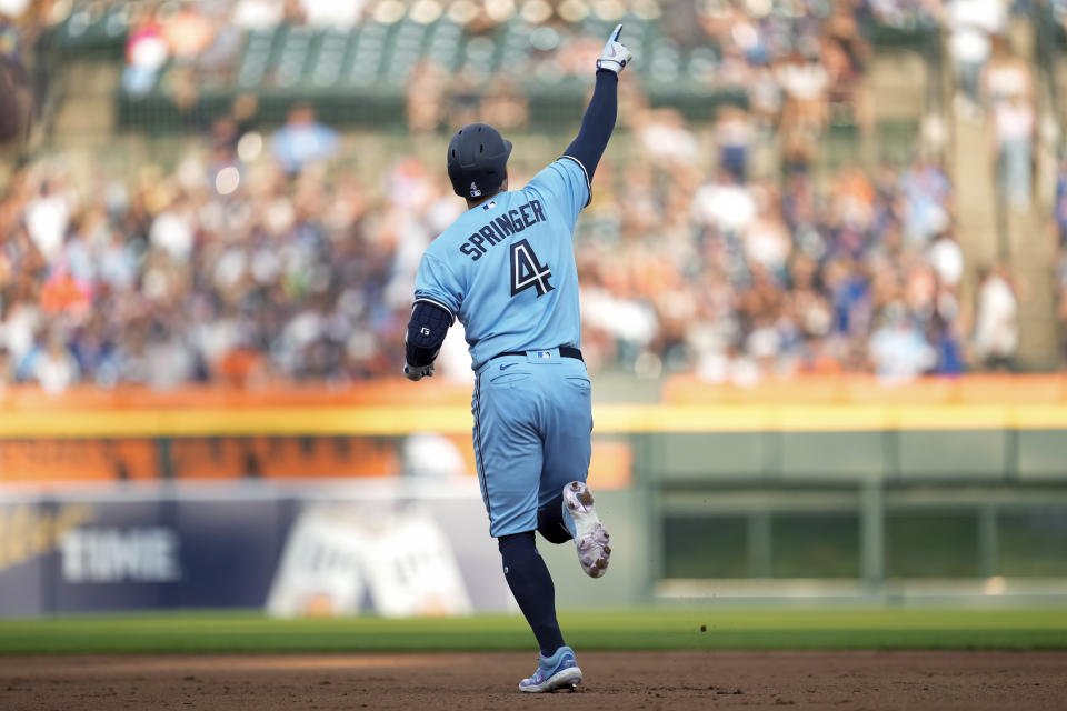 Toronto Blue Jays' George Springer celebrates his two-run home run against the Detroit Tigers in the fourth inning of a baseball game, Friday, July 7, 2023, in Detroit. (AP Photo/Paul Sancya)