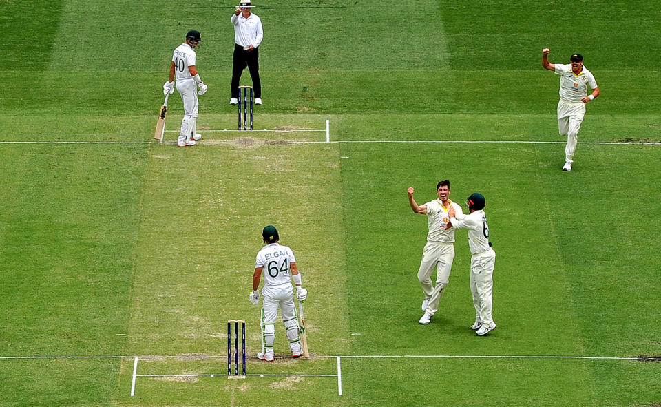 Pat Cummins celebrates after taking the wicket of Dean Elgar in the first Test at the Gabba. (Photo by Bradley Kanaris/Getty Images)