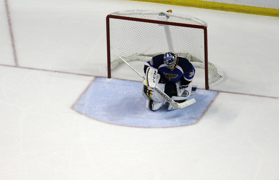 St. Louis Blues goalie Ryan Miller pauses after giving up the game-winning goal to Chicago Blackhawks' Jonathan Toews during overtime in Game 5 of a first-round NHL hockey playoff series Friday, April 25, 2014, in St. Louis. The Blackhawks won 3-2. (AP Photo/Jeff Roberson)