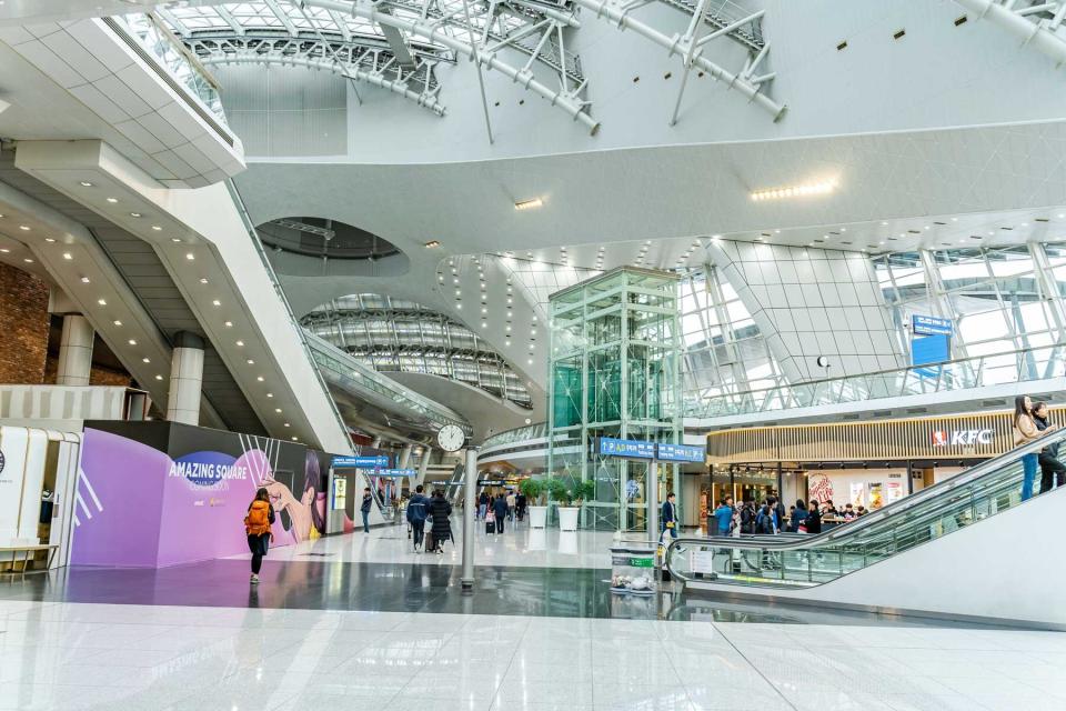 People transit the Incheon International Airport, South Korea