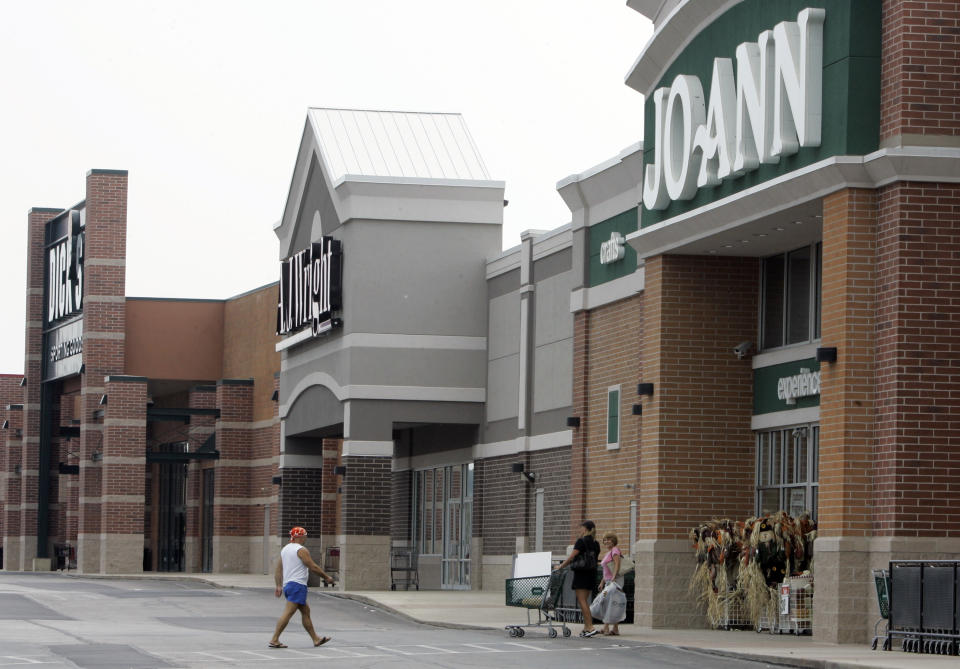 People walk into and out of a JoAnn store, Thursday, Sept. 6, 2007, in Garfield Heights, Ohio. Retailers got a pleasant surprise in August, as shoppers went on a late back-to-school buying spree, helping business rebound from a disappointing pace in July. But analysts are still worried about shopping during the fall and critical holiday seasons amid a weakening housing market and widening credit problems. (AP Photo/Tony Dejak)