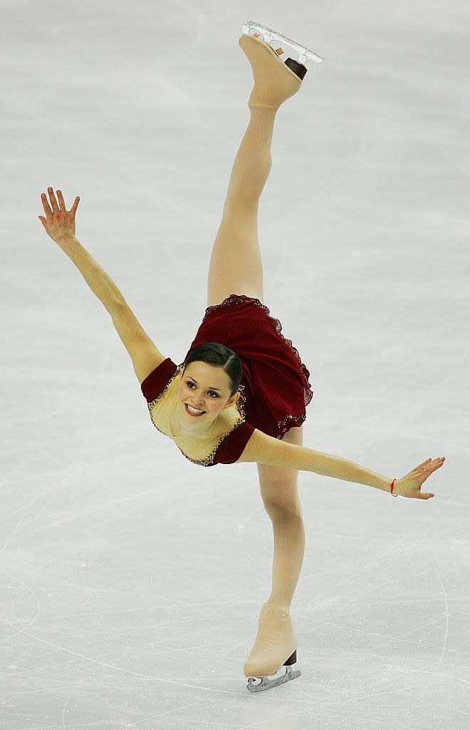 sasha cohen inskating in 2006 with a smile on her face
