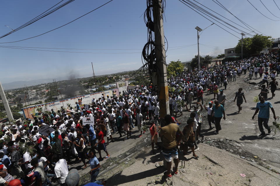 Protesters led by the art community demand the resignation of Haitian President Jovenel Moise as they march through Port-au-Prince, Haiti, Sunday, Oct. 13, 2019. Protests have paralyzed the country for nearly a month, shuttering businesses and schools. (AP Photo/Rebecca Blackwell)