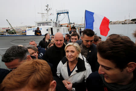 Marine Le Pen (C), French National Front (FN) political party candidate for French 2017 presidential election, leaves a fishing boat after a campaign visit to the port in Grau-du-Roi, France, April 27, 2017. REUTERS/Jean-Paul Pelissier