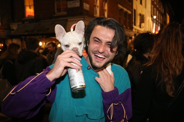 A man with a dog out in Soho, central London 