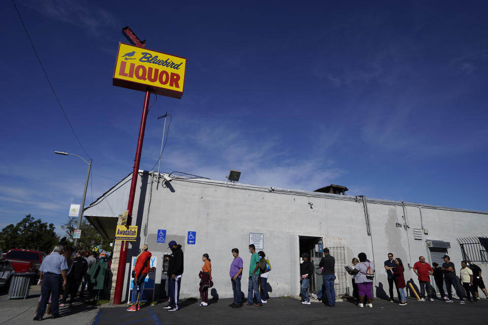 People line up to purchase lottery tickets for the Saturday drawing of the Powerball lottery at the Bluebird Liquor store in Hawthorne, Calif., Saturday, Nov. 5, 2022. (AP Photo/Damian Dovarganes)