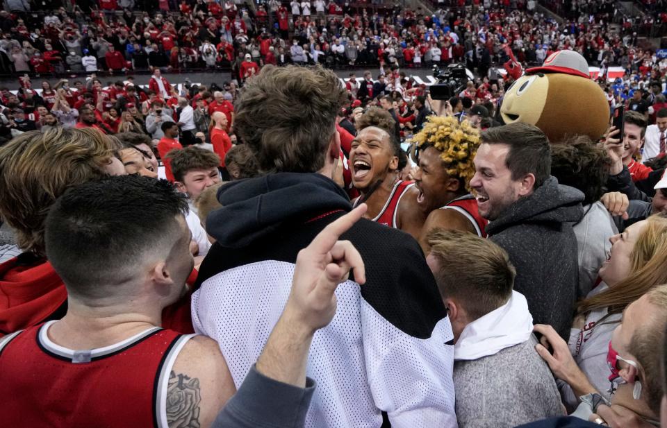 Ohio State Buckeyes players and fans storm the court following the NCAA men's basketball game against the Duke Blue Devils at Value City Arena in Columbus on Tuesday, Nov. 30, 2021. Ohio State won 71-66.