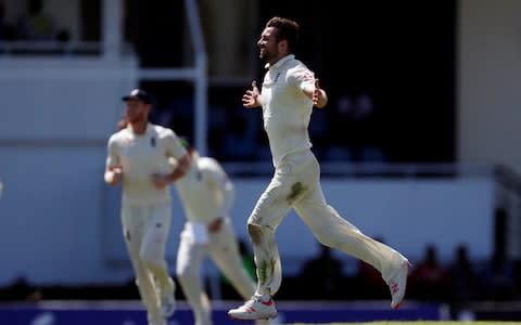 England's Mark Wood celebrates taking the wicket of West Indies' Shai Hope  - Credit: Action Images via Reuters/Paul Childs