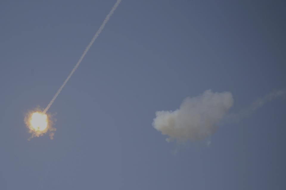 An Israeli Iron Dome air defense system missile is seen intercepting rockets fired from Gaza over Sderot, southern Israel, Wednesday, Nov. 13, 2019. (AP Photo/Ariel Schalit)