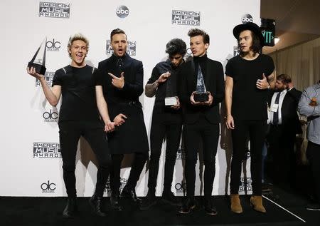 One Direction poses backstage with their awards for Favorite Rock/Pop Band/Duo/Group, Artist of the Year and Favorite Rock/Pop Album for "Midnight Memories" during the 42nd American Music Awards in Los Angeles, California November 23, 2014. REUTERS/Danny Moloshok