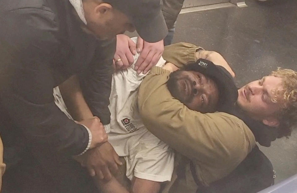 Neely is held in a chokehold by a fellow subway passenger on May 1.