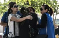 Anxious relatives of passengers who were flying aboard the EgyptAir plane that crashed into the Mediterranean, console each other outside Cairo airport, on May 19, 2016