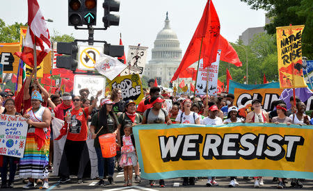 Demonstrators march down Pennsylvania Avenue during a People's Climate March, to protest U.S. President Donald Trump's stance on the environment, in Washington, U.S., April 29, 2017. REUTERS/Mike Theiler