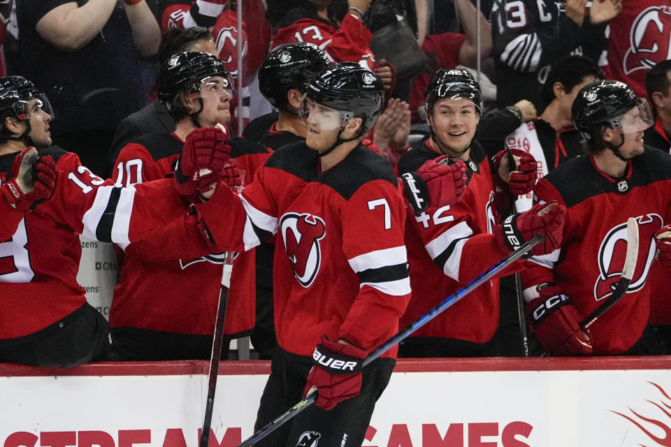 New Jersey Devils' Dougie Hamilton (7) is congratulated for his goal against the Detroit Red Wings during the third period of an NHL hockey game Thursday, Oct. 12, 2023, in Newark, N.J. (AP Photo/Frank Franklin II)