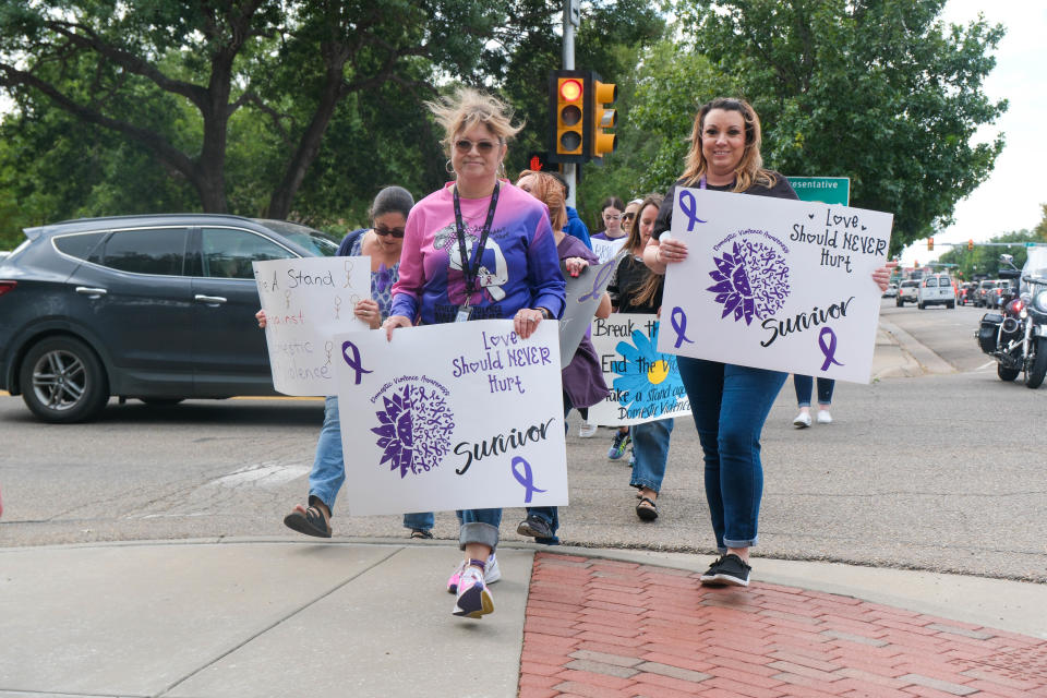 Members of the Amarillo community march to the Potter County Courthouse during the walk against domestic violence Monday afternoon in downtown Amarillo.