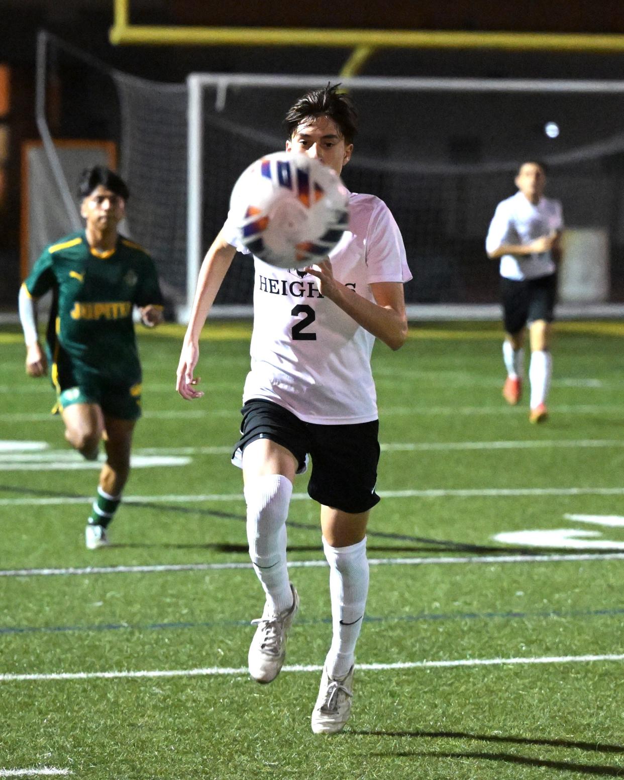 Olympic Heights' Leo Burguete races downfield, controlling the ball in the final third in a regional quarterfinals match against Jupiter on Feb. 13, 2024.