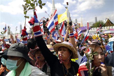 Anti-government protesters blow whistles as they gather outside the Defense Ministry in central Bangkok November 28, 2013. REUTERS/Damir Sagolj