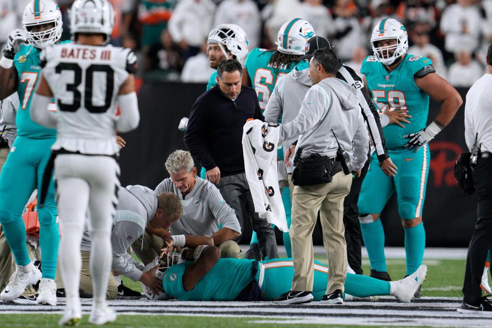 Miami Dolphins quarterback Tua Tagovailoa is examined during the first half of the team's NFL football game against the Cincinnati Bengals, Thursday, Sept. 29, 2022, in Cincinnati. (AP Photo/Jeff Dean)