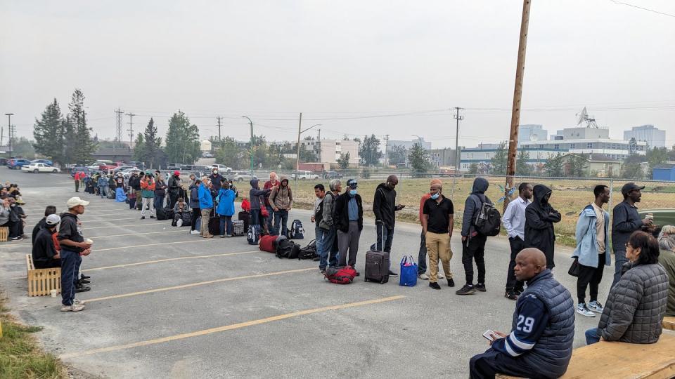 People without vehicles line up to register for a flight to Calgary in Yellowknife on Aug. 17, 2023. THE CANADIAN PRESS/Bill Braden