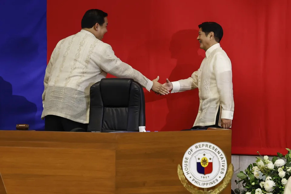 Philippines President Ferdinand Marcos Jr. right, shakes hands with House Speaker Martin Romualdez ahead of the State of the Nation Address at the House of Representatives in Quezon City, Philippines, on Monday, July 22, 2024. (AP Photo/ Gerard V. Carreon)