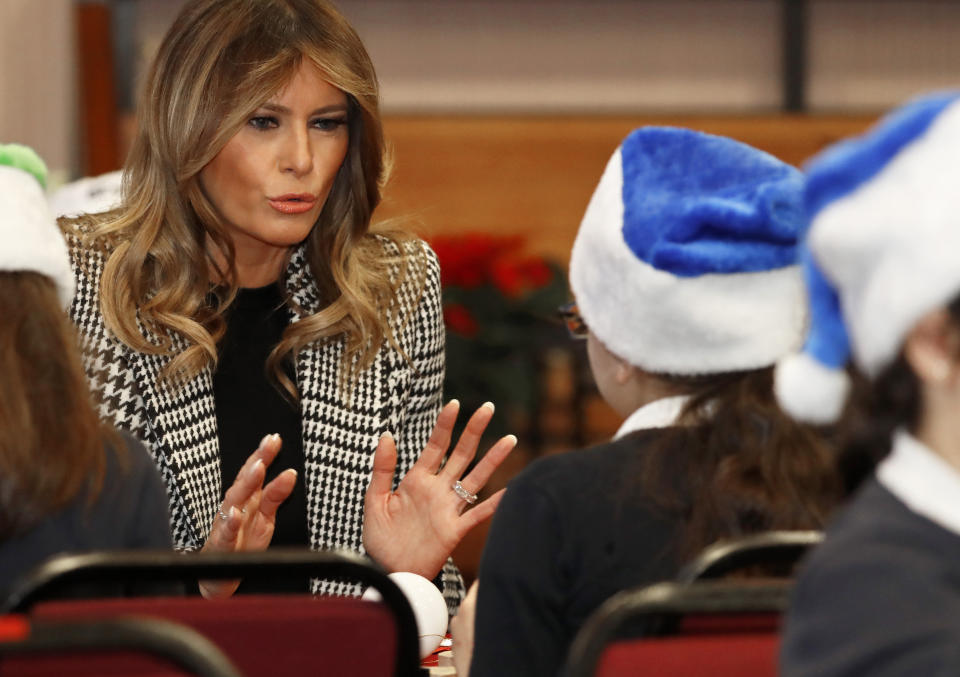 First lady Melania Trump joins local school students creating holiday decorations at the Salvation Army Clapton Center in London, Wednesday, Dec. 4, 2019. (AP Photo/Alastair Grant)