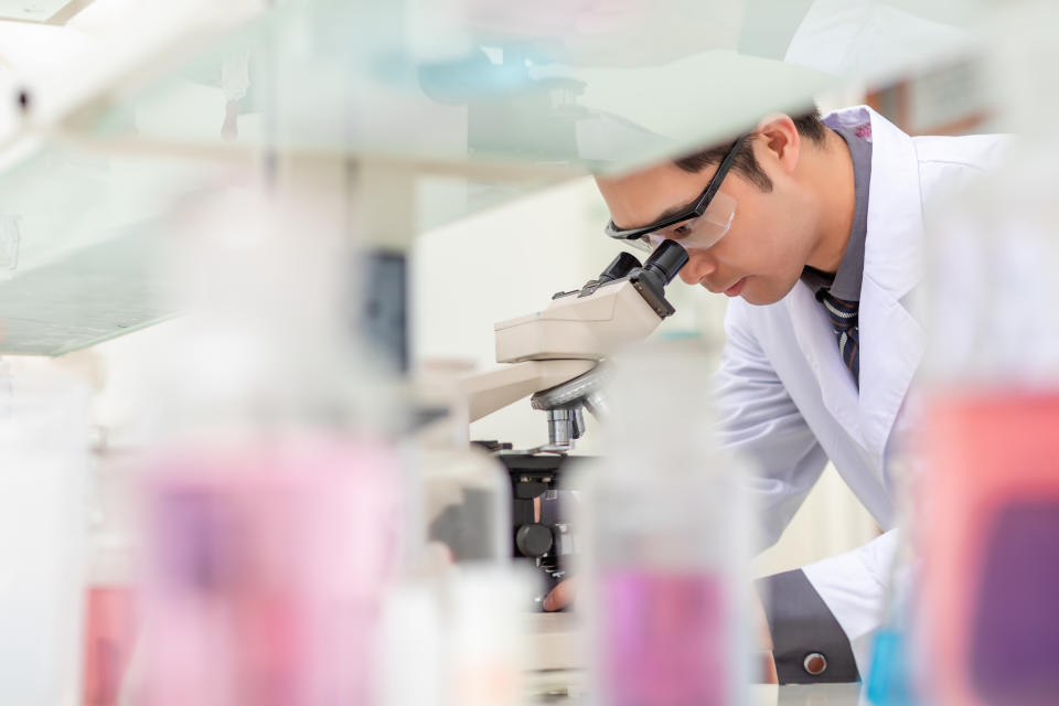 An Asian men work hard in the chemistry laboratory