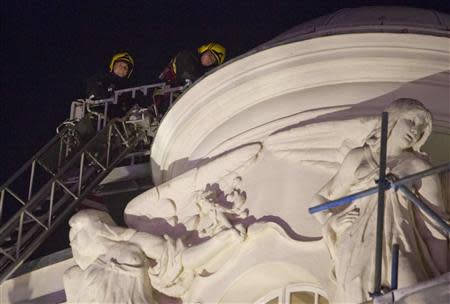 Emergency services look at the roof of the Apollo Theatre on Shaftesbury Avenue cafter part of the ceiling collapsed in central London December 19, 2013. REUTERS/Neil Hall