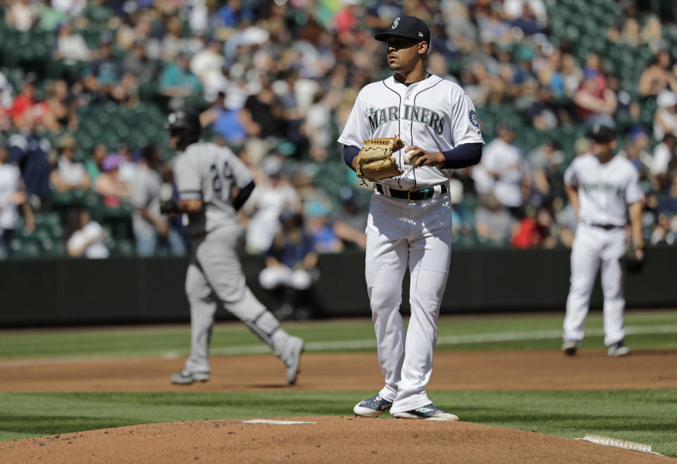 Seattle Mariners starting pitcher Justus Sheffield, center, stands on the mound as New York Yankees Gary Sanchez, left, rounds the bases after Sanchez hit a two-run home run during the first inning of a baseball game, Wednesday, Aug. 28, 2019, in Seattle. (AP Photo/Ted S. Warren)